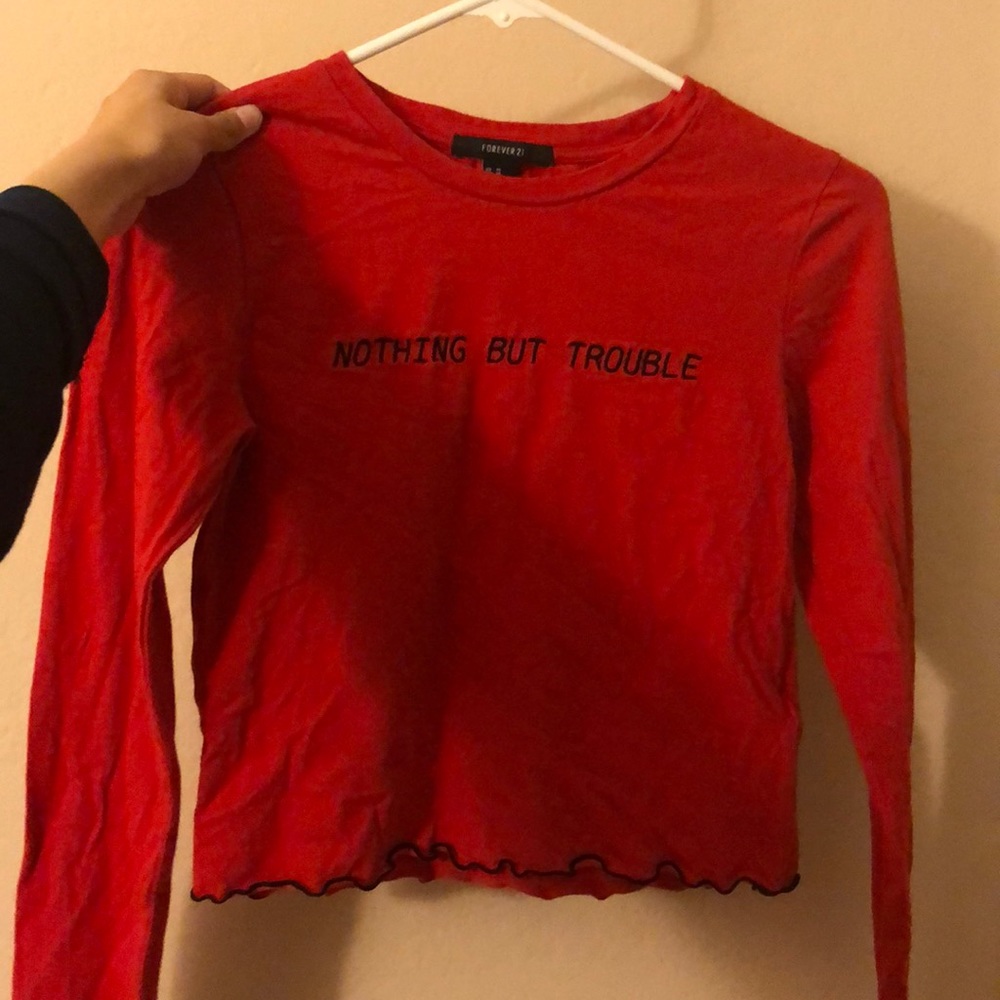 red “nothing but trouble” long sleeve crop top